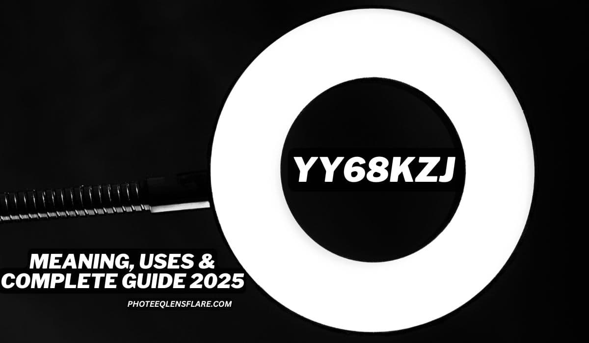 A close-up image of a bright circular ring light on a black background, with a flexible gooseneck arm attached to it. In the center of the ring light is bold white text "YY68KZJ" over a black strip. At the bottom left, the text reads "MEANING, USES & COMPLETE GUIDE 2025" with the source "PhoteeQlensFlare.com" below it. The image appears to promote a digital or tech-related guide or identifier.