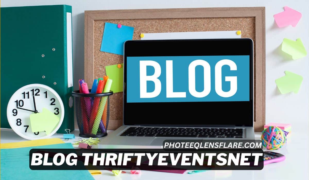A colorful and organized workspace featuring a laptop displaying the word “BLOG” on the screen in bold white letters against a blue background. Surrounding the laptop are office supplies including a pencil holder with pens and highlighters, sticky notes, a clock showing 10:10, a green binder, and a corkboard with pinned notes. The text overlay reads "BLOG THRIFTYEVENTSNET" with the website "PhoteeqLensFlare.com" promoting a blog-related platform.