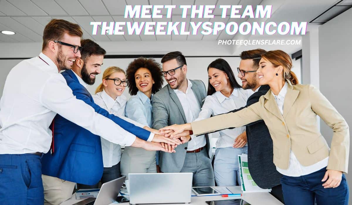 A diverse and cheerful group of office professionals stands around a table, reaching into the center with their hands stacked together in a team gesture. Laptops and documents are visible on the table. Text at the top reads: "MEET THE TEAM THEWEEKLYSPOONCOM" and "PHOTEEQLENSFLARE.COM" in bold, colorful font.
